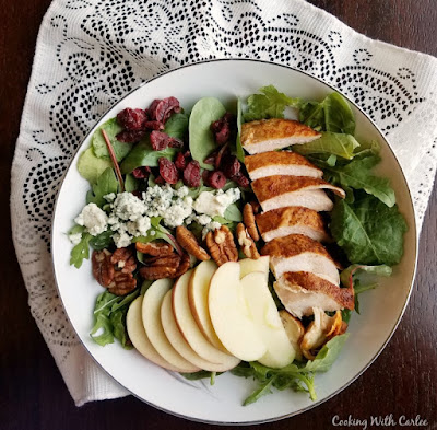The crunch of fresh apples, the sweetness of dried cranberries, savory chicken and cheese, and fresh greens come together in this great salad that helps bridge the seasons when you still want something light but fall flavors are calling your name! The homemade dressing is perfect for all kinds of salads as well! big bowl of fall dinner salad