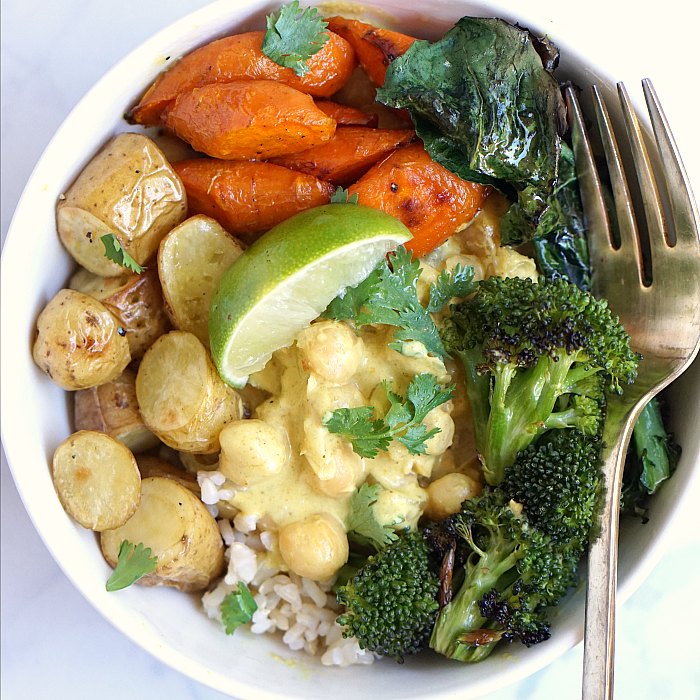 coconut chickpea curry bowl Coconut chickpea curry bowl with rice, broccoli, carrots, and potatoes.