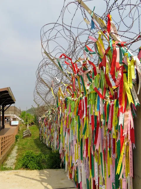 Barbed wire and ribbons with messages of hope in the DMZ in South Korea