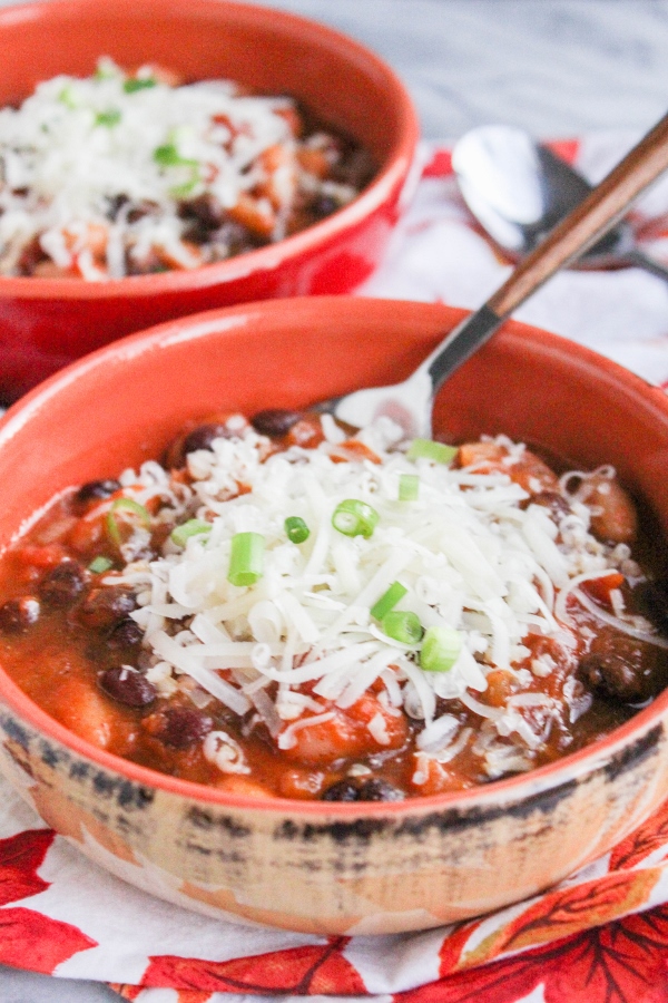 This Pumpkin Chili is loaded with veggies and two kinds of beans, and is a hearty and delicious vegetarian chili recipe. It's perfect for those chilly Fall days!