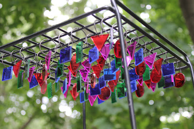 multicolored plastic prisms hanging from a metal rack