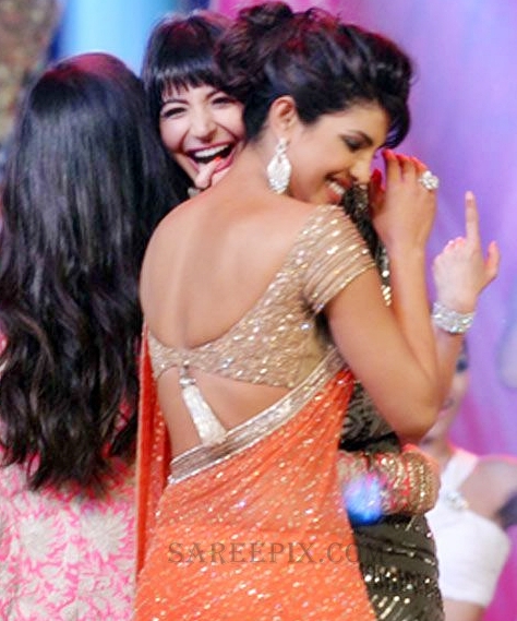Priyanka Chopra hot back in saree, Priyanka Chopra in orange saree, Priyanka Chopra hugging anushka sharma