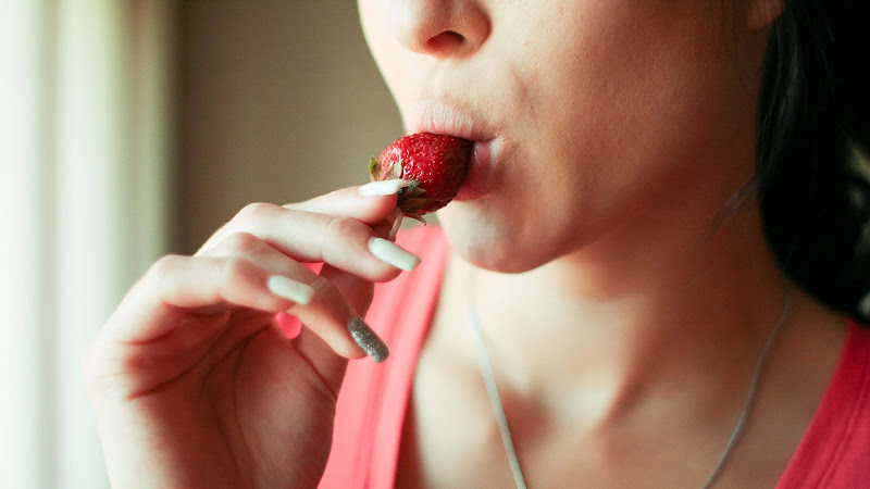 Girl Eating a Strawberry HD