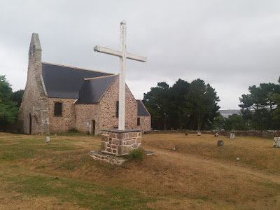 A small, pretty Celtic-Style Church with a neatly kept churchyard.