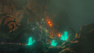 screenshot of Zelda riding an elephant through a dark cave
