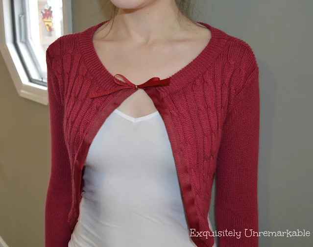 Girl wearing a DIY cardigan sweater over a white tank top