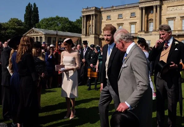 Meghan Markle wore Goat Fashion Flavia Dress, and Tamara Mellon 'Siren' blush nappa leather pumps, she carried Wilbur and Gussie bespoke silk clutch