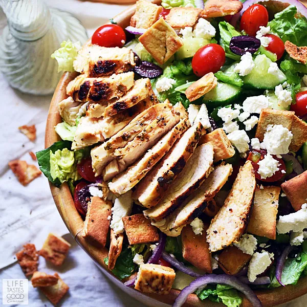 Gyros salad with chicken in a large wooden serving bowl