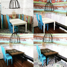 Four versions of a modern miniature scene comprising two blue chairs, a dining table and an industrial-style light fitting. The wall and floor treatments vary between the pictures.