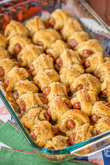 Glazed Pigs in a Blanket - pigs in a blanket baked in a sweet and savory brown sugar glaze. Took these to a party and they were gone in minutes!!! Crescent rolls, dijon mustard, little smokies, brown sugar, butter, poppy seeds and Worcestershire sauce. I have zero self-control around these things! Dangerously delicious!! A MUST for all your tailgates and parties! #tailgating #Pigsinablanket #partyfood #appetizer Glazed Pigs in a Blanket - pigs in a blanket baked in a sweet and savory brown sugar glaze. Took these to a party and they were gone in minutes!!! Crescent rolls, dijon mustard, little smokies, brown sugar, butter, poppy seeds and Worcestershire sauce. I have zero self-control around these things! Dangerously delicious!! A MUST for all your tailgates and parties! #tailgating #Pigsinablanket #partyfood #appetizer