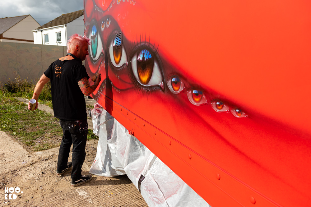 Street Artist My Dog Sighs spray painting a truck in Cheltenham, UK
