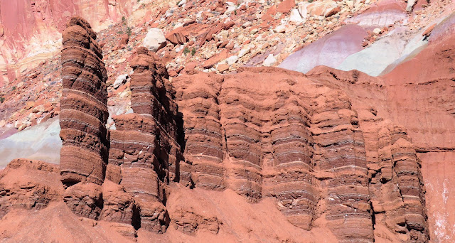 Columnar formations with darker and lighter red layers.