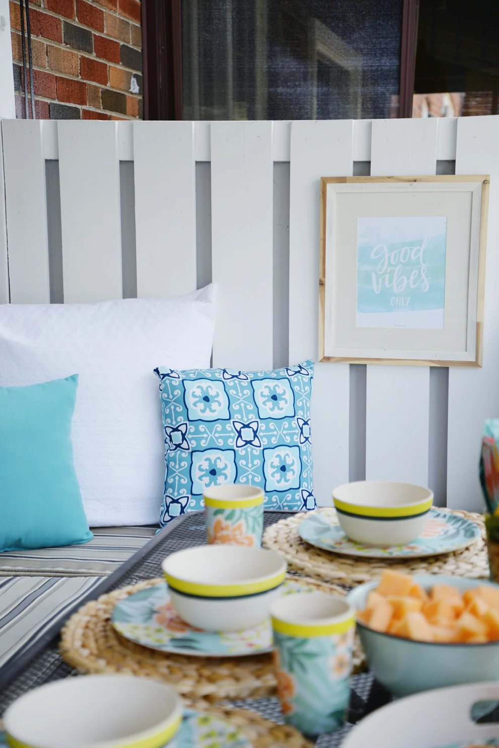 Rambling Renovators | tropical decor, outdoor pillows, blue white rattan decor, good vibes only print