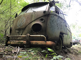 Ground eroded by water on driver's side of 1965 VW bus.