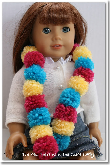 Make this adorable American Girl Doll craft of a Pom Pom Scarf for your doll. Too Cute! #AGDoll #Crafts #AmericanGirlDoll #RealCoake