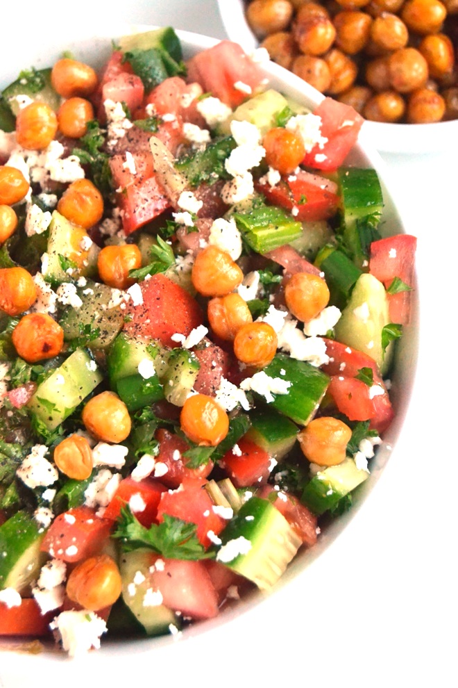 Greek Chopped Salad with Roasted Chickpeas is so delicious with chopped cucumber, tomato, green onion, parsley, feta cheese, crunchy roasted chickpeas and a fresh lemon vinaigrette for a delicious, nutritious side dish! www.nutritionistreviews.com