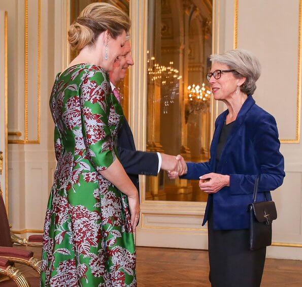 Queen Mathilde wore a green floral-print satin dress by Natan. Édouard, baron Vermeulen is a Belgian fashion designer. Natan red suede pumps