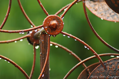 rain drops on wind sculpture photo by mbgphoto