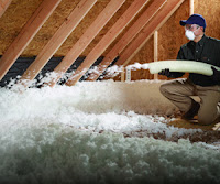 Blown-in fiberglass insulation in attic Blown-in fiberglass insulation in attic