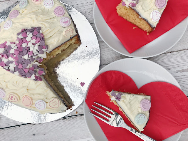 Cake with two slices cut and plated with heart napkins