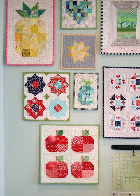 Wall of mini quilts from A Bright Corner