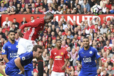 Paul Pogba of Manchester United jumps to head a ball against Leicester City in a Premier League match Manchester United post record quarterly profit