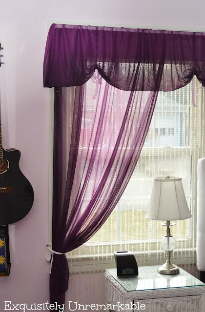 Purple Sheer Curtains on window with guitar on wall