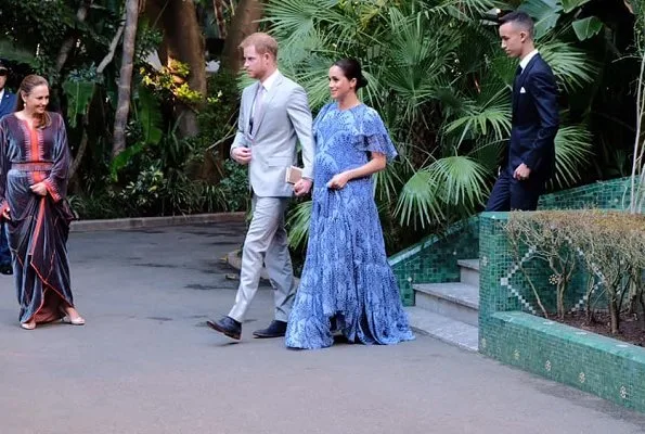 Meghan Markle wore Carolina Herrera floral printed silk chiffon short sleeve gown, and she carries Dior Bee embellished clutch