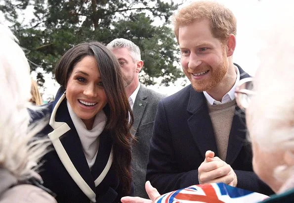 Meghan Markle wore J.Crew coat, Manolo Blahnik pumps, All Saints Ridley jumper, Alexander Wang Pants and carried Altuzarra Ghianda shoulder bag