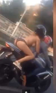 2 Woman is filmed riding on a bike dressed in just her panties and a pair of trainers