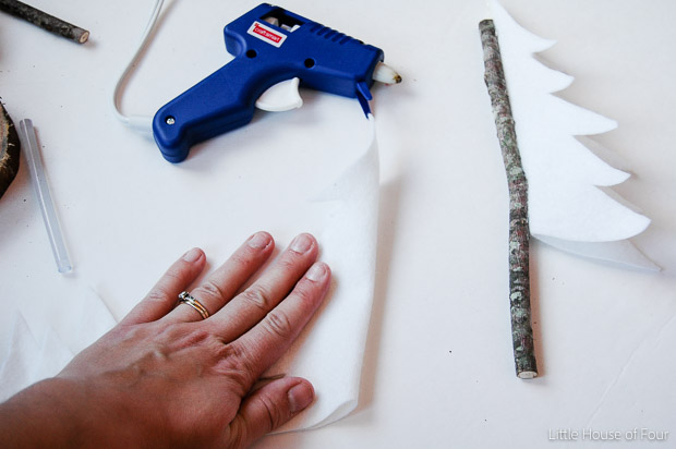 Create these super easy (and inexpensive!) felt trees for a fraction of the price! Find the tutorial at Littlehouseoffour.com Gluing felt to twigs for rustic felt trees