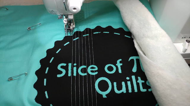 Quilted tote bag with Slice of Pi Quilts logo