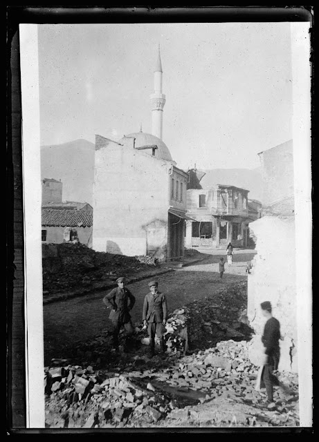 Carl Randan & Capt. Aupperle in Monastir. A Minaret working a Mohammedan mosque, in the rear. These minarets have an interior circular stairway & several times daily a "Muezzin" or priest climbs up and shouts a Jew prayer from the little balcony