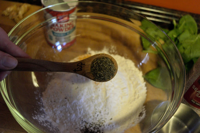 Pepper being added to the bowl of flour. 