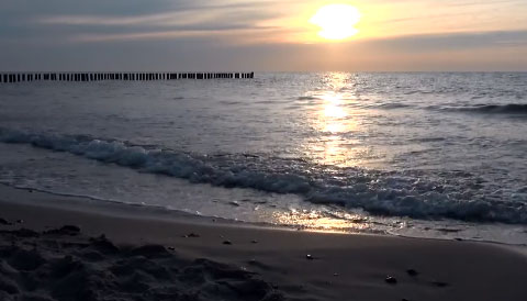 Lapping waves reflecting a beautiful sunset on a quiet beach. Lapping waves reflecting a beautiful sunset on a quiet beach. Set up for use with Tar Heel and switch accessibility for cause and effect use.
