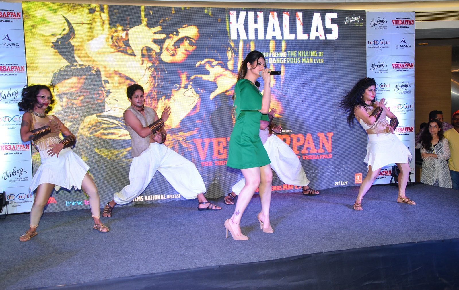 Zareen Khan Displays Her Sexy Legs In a Green Short Dress At The â€œKhallasâ€ Song Launch From Film Veerappan