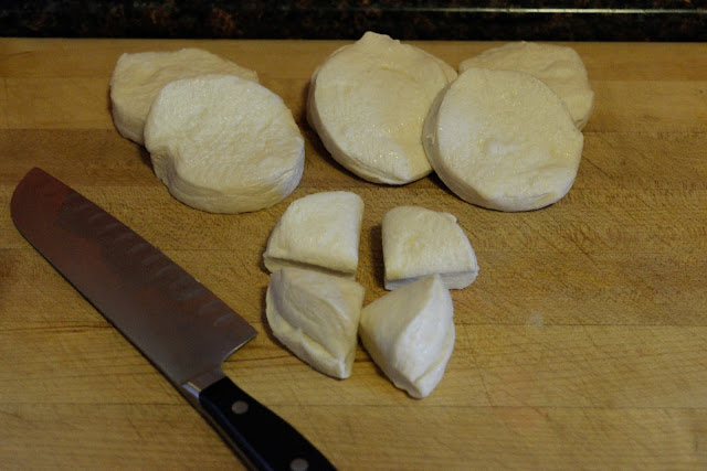 The canned biscuits being cut into fours.  