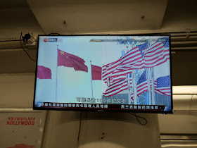 China and US flags displayed on a news segment about the China - US trade discussions