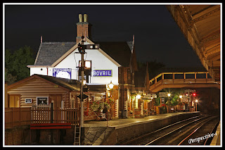 A nightime after dark view of Bewdley Station looking North from the centre platform back towards the station building and footbridge