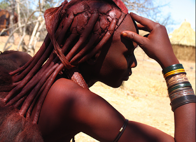 African Himba covers their skin and hair  with a creamy mixture of fat and red clay