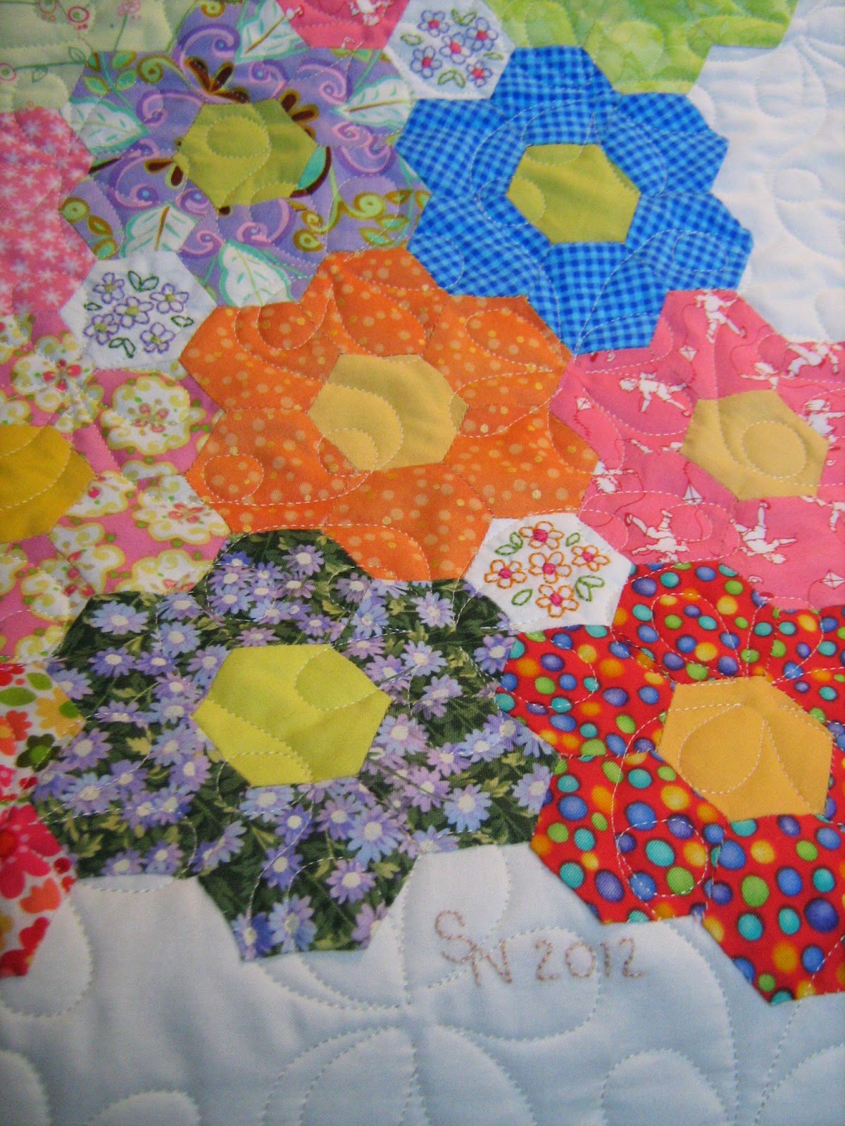 Inch by Inch Quilting Grandmother’s Flower Garden quilt by Sharon