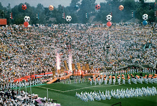 Image description: Full soccer stadium with a pyrotechnics show.