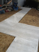 newly laid concrete path through dirt