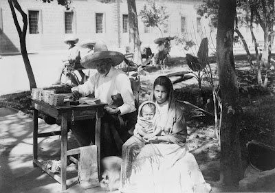 Man%2BWriting%2BLetter%2Bwith%2BWoman%2BHolding%2BBaby