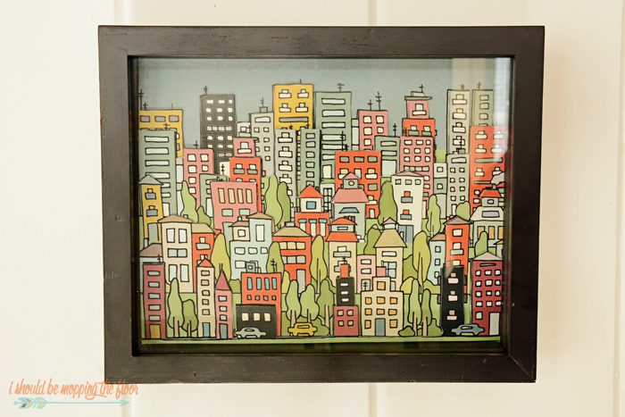 DIY 3D Artwork with Free Printable Background | Download this cityscape and learn how to create this fun 3 dimensional piece of art with simple mounting tape and cutting. 