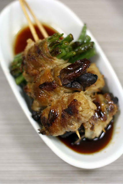 bacon wrapped asparagus, shitake, and enoki mushrooms glazed with sweet teriyaki sauce 