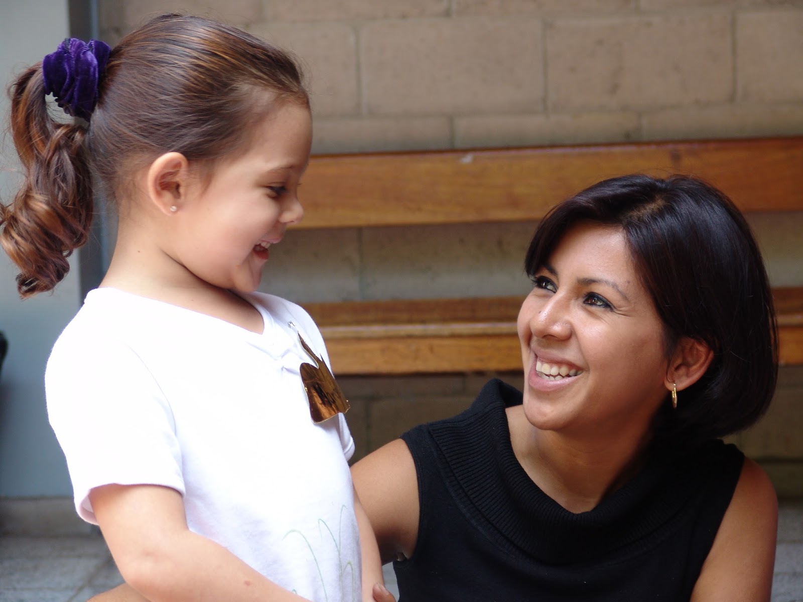 NAMC montessori girl smiling at teacher beginning of the school year