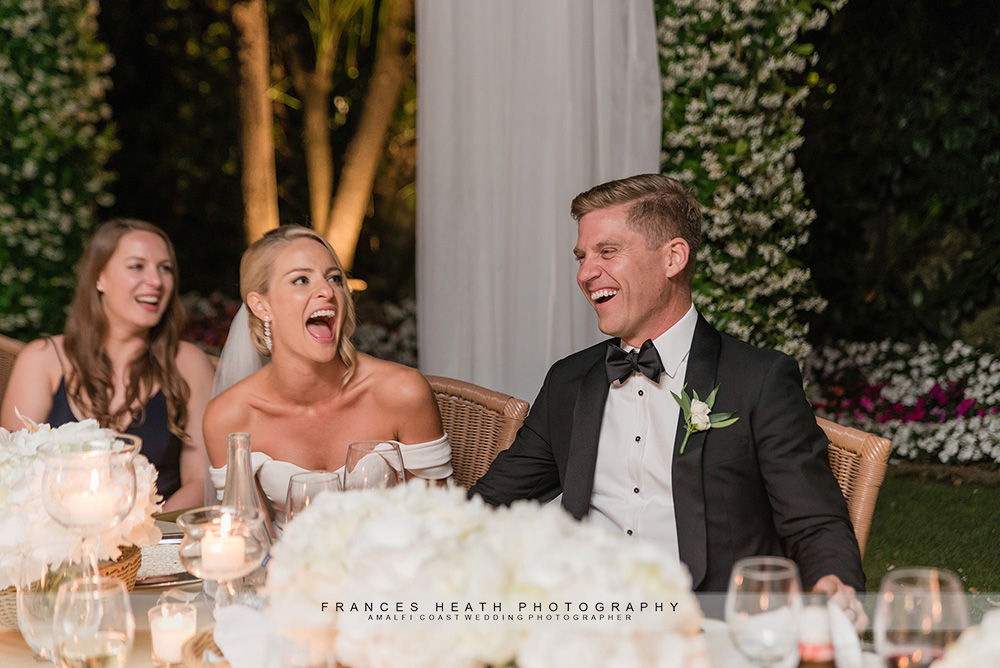 Bride and groom laughing during speech
