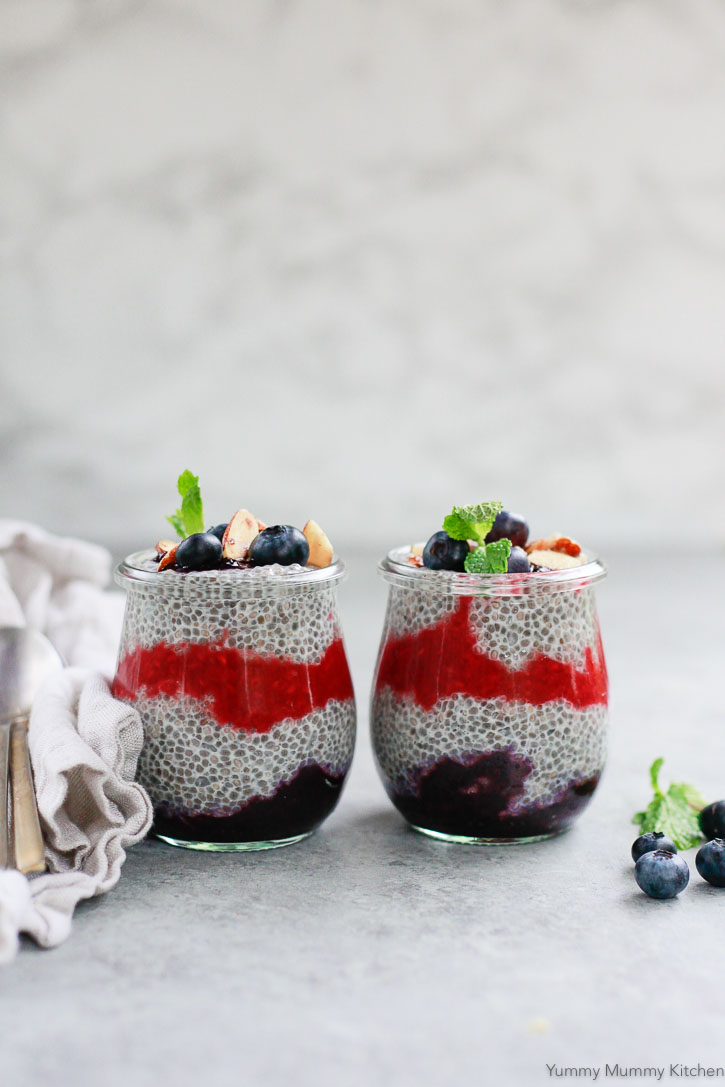 Chia Pudding Recipe Beautiful photo of chia pudding prepared with layers of berries and fresh mint on top.