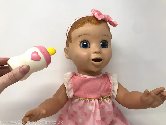 The luvabella doll interacts with a milk bottle, soother and spoon